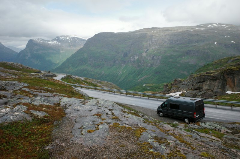 A black van on a winding mountain road